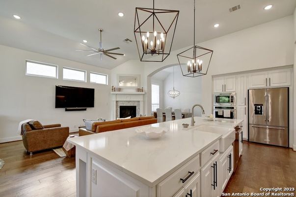 Fireplace, Interior, Kitchen, Living room, Pendant Lights, Recessed Lighting, Stainless Steel Appliances, Wood Texture Flooring