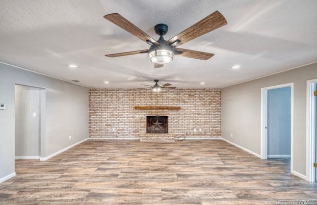 Empty room, Fireplace, Interior, Recessed Lighting, Stone Walls, Wood Texture Flooring