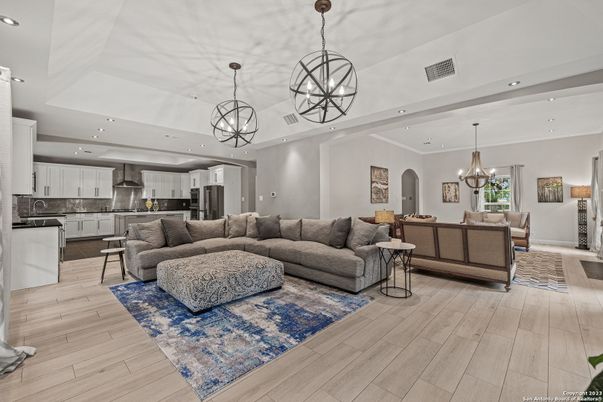 Chandelier, Dining room, Interior, Kitchen, Living room, Pendant Lights, Recessed Lighting, Stainless Steel Appliances, Wood Texture Flooring