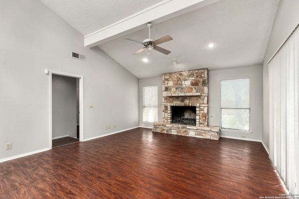 Empty room, Fireplace, Interior, Recessed Lighting, Stone Walls, Wood Texture Flooring