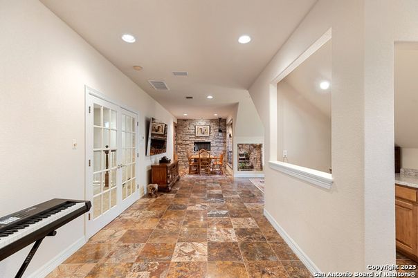 Dining room, Fireplace, Interior, Piano, Recessed Lighting, Stone Walls