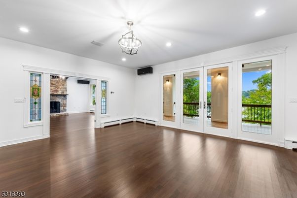 Empty room, Fireplace, Interior, Recessed Lighting, Stone Walls, Wood Texture Flooring