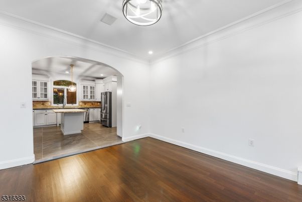 Empty room, Interior, Kitchen, Recessed Lighting, Stainless Steel Appliances, Wood Texture Flooring