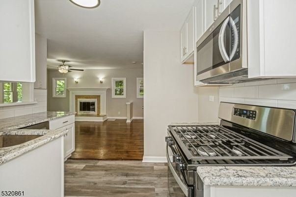 Fireplace, Interior, Kitchen, Stainless Steel Appliances, Wood Texture Flooring