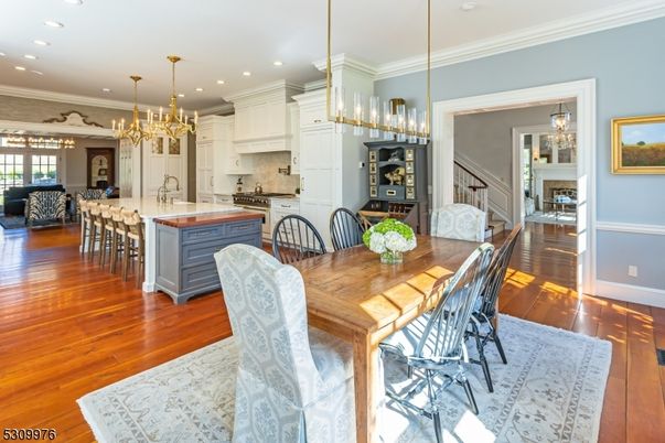 Chandelier, Dining room, Interior, Kitchen, Living room, Pendant Lights, Recessed Lighting, Stainless Steel Appliances, Wood Texture Flooring