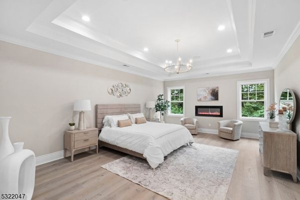 Bedroom, Chandelier, Fireplace, Interior, Recessed Lighting, Wood Texture Flooring