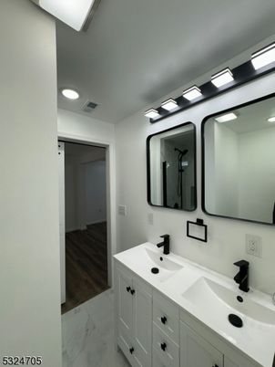 Bathroom, Dual Sink Vanities, Interior, Marble, Recessed Lighting, Wood Texture Flooring