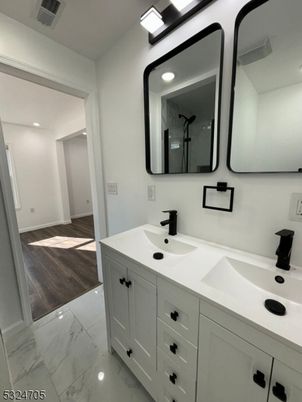 Bathroom, Dual Sink Vanities, Interior, Marble, Recessed Lighting, Wood Texture Flooring