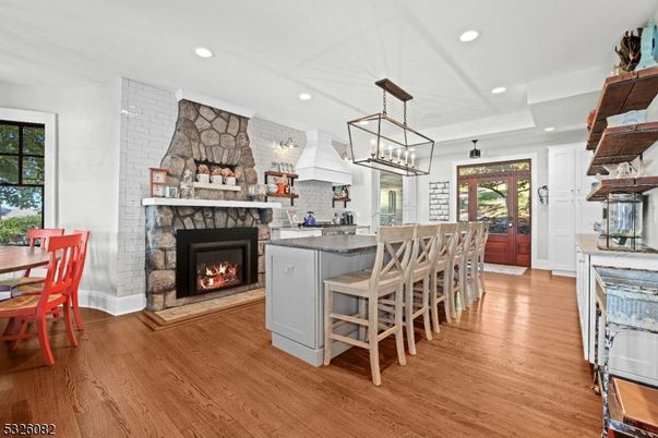Chandelier, Dining room, Fireplace, Interior, Kitchen, Pendant Lights, Recessed Lighting, Stone Walls, Wood Texture Flooring