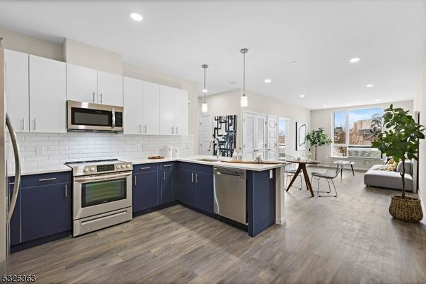 Dining room, Interior, Kitchen, Pendant Lights, Recessed Lighting, Stainless Steel Appliances, Wood Texture Flooring