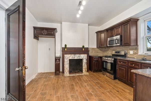 Fireplace, Interior, Kitchen, Stainless Steel Appliances, Wood Texture Flooring