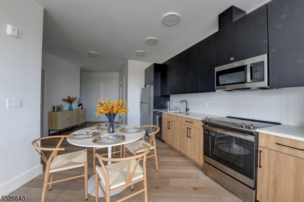 Dining room, Interior, Kitchen, Recessed Lighting, Stainless Steel Appliances, Wood Texture Flooring