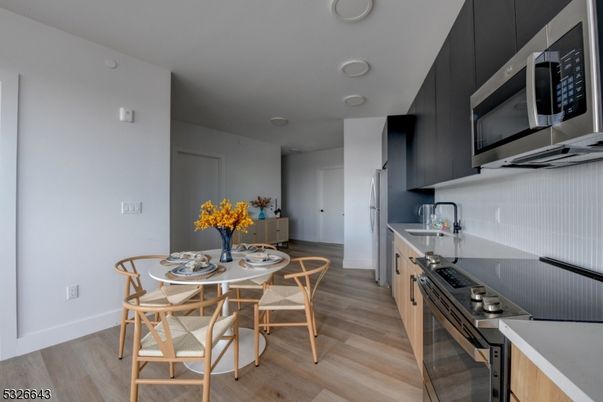 Dining room, Interior, Kitchen, Recessed Lighting, Stainless Steel Appliances, Wood Texture Flooring