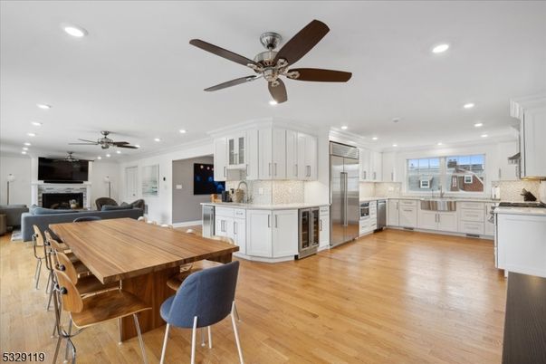Dining room, Fireplace, Interior, Kitchen, Living room, Recessed Lighting, Stainless Steel Appliances, Wood Texture Flooring