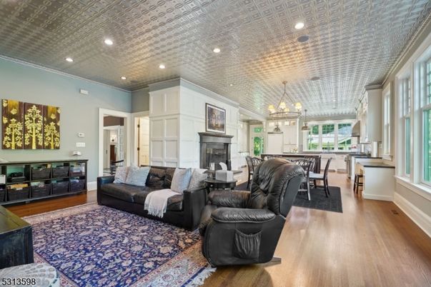 Chandelier, Dining room, Fireplace, Interior, Living room, Pendant Lights, Recessed Lighting, Wood Texture Flooring