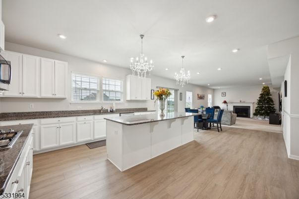 Chandelier, Dining room, Fireplace, Interior, Kitchen, Recessed Lighting, Wood Texture Flooring