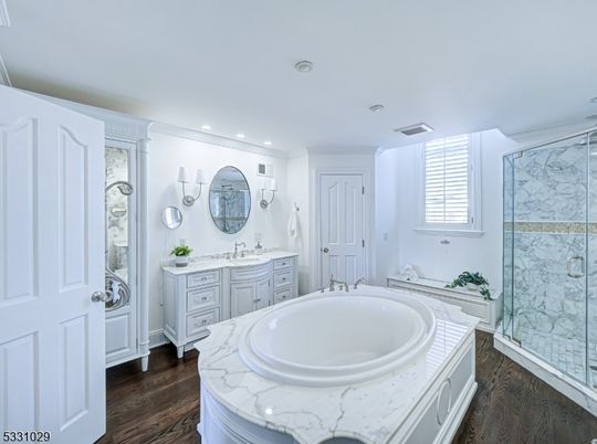 Bathroom, Dual Sink Vanities, Glass Shower, Interior, Marble Walls, Recessed Lighting, Wood Texture Flooring