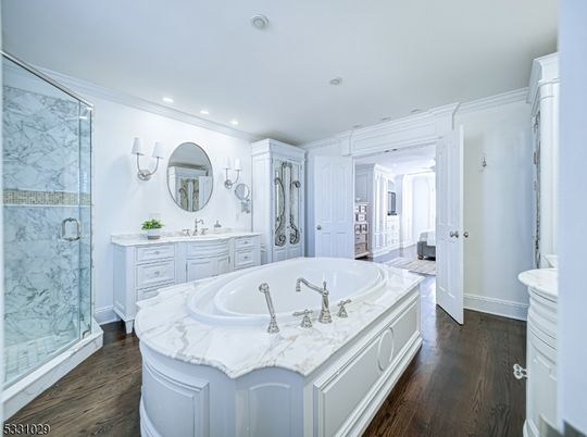 Bathroom, Dual Sink Vanities, Glass Shower, Interior, Marble Walls, Recessed Lighting, Wood Texture Flooring