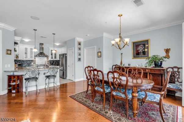 Chandelier, Dining room, Interior, Kitchen, Pendant Lights, Recessed Lighting, Stainless Steel Appliances, Wood Texture Flooring