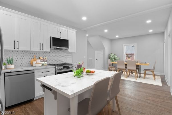 Dining room, Interior, Kitchen, Recessed Lighting, Stainless Steel Appliances, Wood Texture Flooring