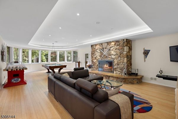 Billiard Table, Fireplace, Game Room, Interior, Living room, Pendant Lights, Recessed Lighting, Stone Walls, Wood Texture Flooring