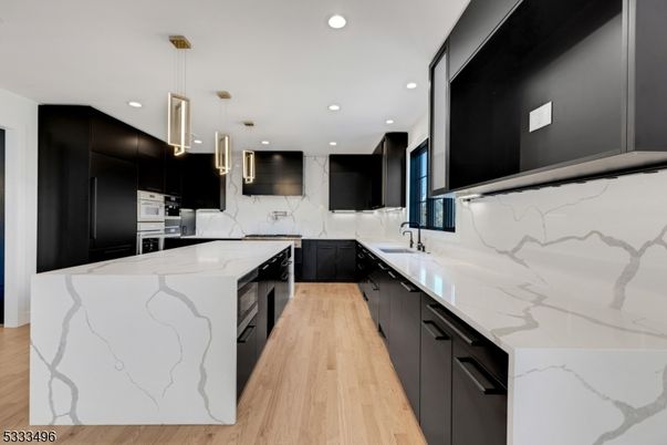 Interior, Kitchen, Marble Walls, Pendant Lights, Recessed Lighting, Stainless Steel Appliances, Wood Texture Flooring