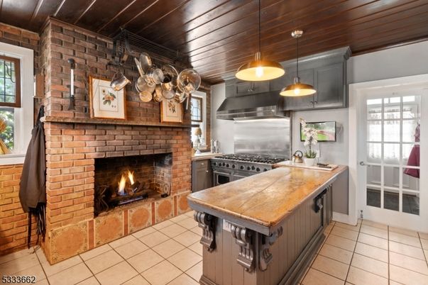 Fireplace, Interior, Kitchen, Pendant Lights, Stainless Steel Appliances, Stone Walls, Wooden Ceilings