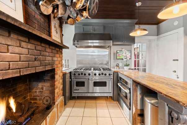 Fireplace, Interior, Kitchen, Pendant Lights, Stainless Steel Appliances, Stone Walls, Wooden Ceilings