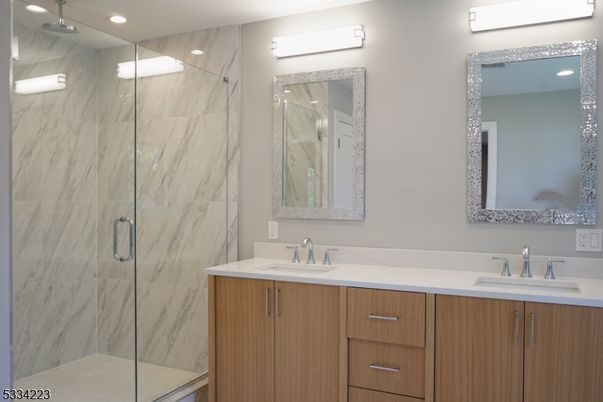 Bathroom, Dual Sink Vanities, Glass Shower, Interior, Marble Walls, Recessed Lighting