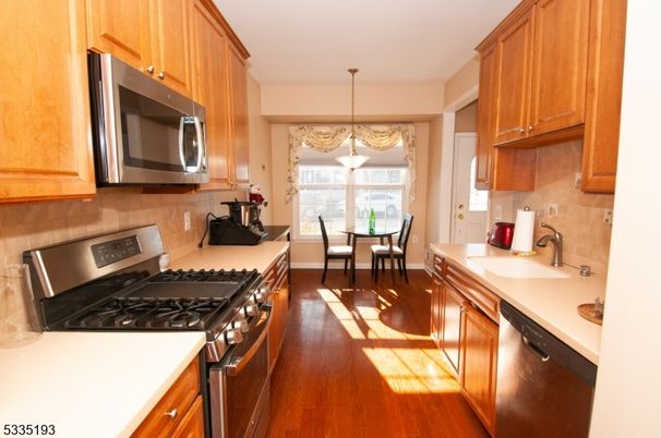 Chandelier, Dining room, Interior, Kitchen, Pendant Lights, Stainless Steel Appliances, Wood Texture Flooring