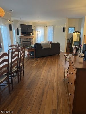 Chandelier, Dining room, Fireplace, Interior, Living room, Pendant Lights, Recessed Lighting, Wood Texture Flooring