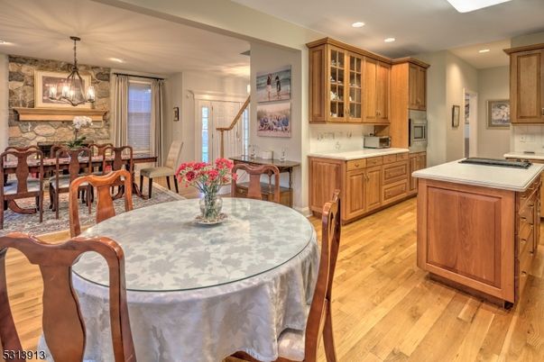 Chandelier, Dining room, Fireplace, Interior, Kitchen, Pendant Lights, Recessed Lighting, Stone Walls, Wood Texture Flooring