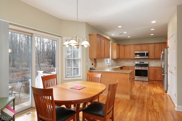 Chandelier, Dining room, Interior, Kitchen, Pendant Lights, Recessed Lighting, Stainless Steel Appliances, Wood Texture Flooring