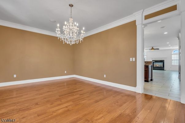 Chandelier, Empty room, Fireplace, Interior, Recessed Lighting, Wood Texture Flooring