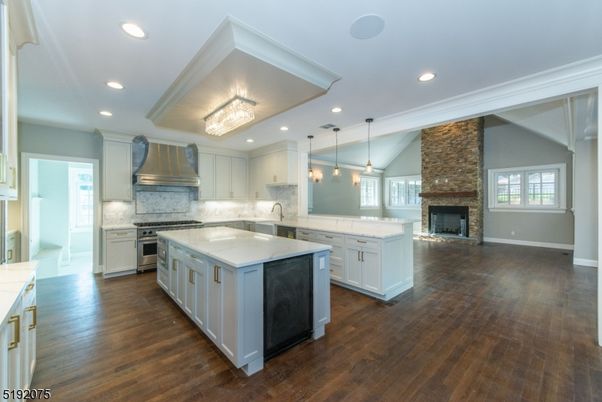 Fireplace, Interior, Kitchen, Pendant Lights, Recessed Lighting, Stainless Steel Appliances, Stone Walls, Wood Texture Flooring