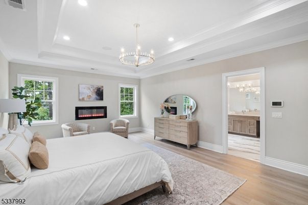 Bedroom, Chandelier, Fireplace, Interior, Pendant Lights, Recessed Lighting, Wood Texture Flooring