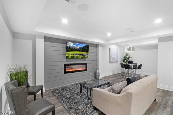 Dining room, Fireplace, Interior, Living room, Recessed Lighting, Wood Texture Flooring