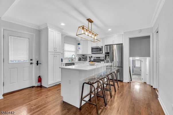 Chandelier, Interior, Kitchen, Pendant Lights, Recessed Lighting, Stainless Steel Appliances, Wood Texture Flooring