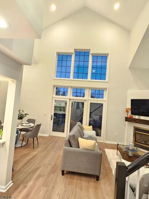 Dining room, Fireplace, Interior, Living room, Recessed Lighting, Wood Texture Flooring