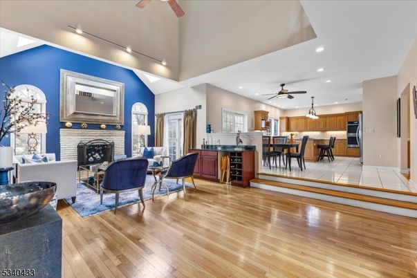 Dining room, Fireplace, Interior, Kitchen, Living room, Recessed Lighting, Stainless Steel Appliances, Wood Texture Flooring