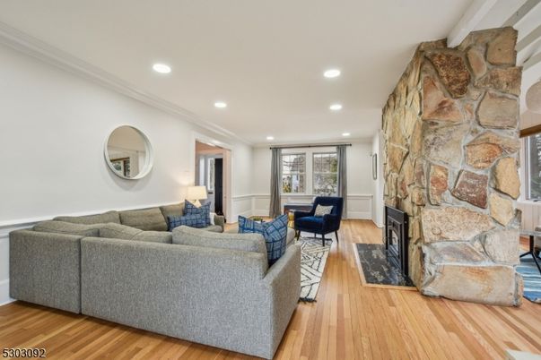 Fireplace, Interior, Living room, Recessed Lighting, Stone Walls, Wood Texture Flooring
