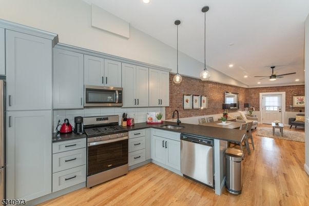 Dining room, Interior, Kitchen, Living room, Pendant Lights, Recessed Lighting, Stainless Steel Appliances, Stone Walls, Wood Texture Flooring