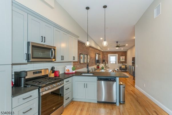 Interior, Kitchen, Pendant Lights, Recessed Lighting, Stainless Steel Appliances, Stone Walls, Wood Texture Flooring
