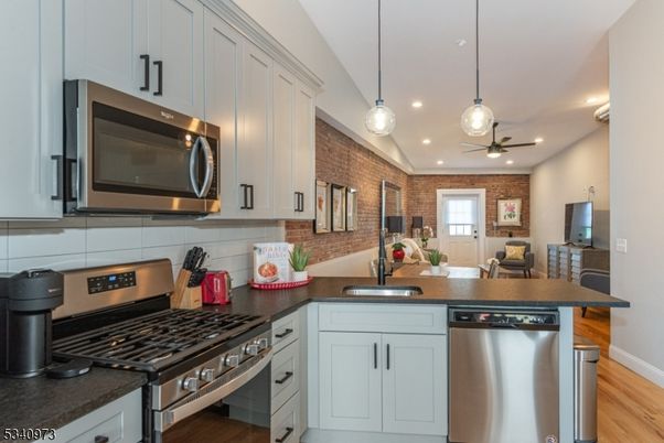 Interior, Kitchen, Pendant Lights, Recessed Lighting, Stainless Steel Appliances, Stone Walls, Wood Texture Flooring