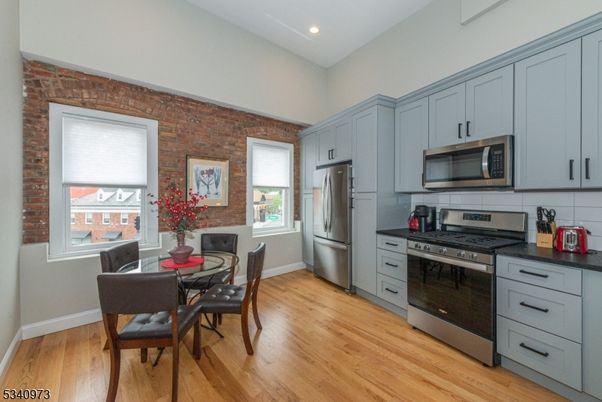 Dining room, Interior, Kitchen, Recessed Lighting, Stainless Steel Appliances, Stone Walls, Wood Texture Flooring