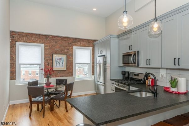 Dining room, Interior, Kitchen, Pendant Lights, Recessed Lighting, Stainless Steel Appliances, Stone Walls, Wood Texture Flooring