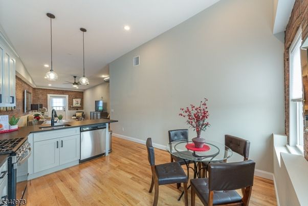 Dining room, Interior, Kitchen, Pendant Lights, Recessed Lighting, Stainless Steel Appliances, Stone Walls, Wood Texture Flooring