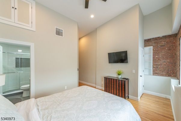 Bathroom, Bedroom, Glass Shower, Interior, Recessed Lighting, Stone Walls, Wood Texture Flooring
