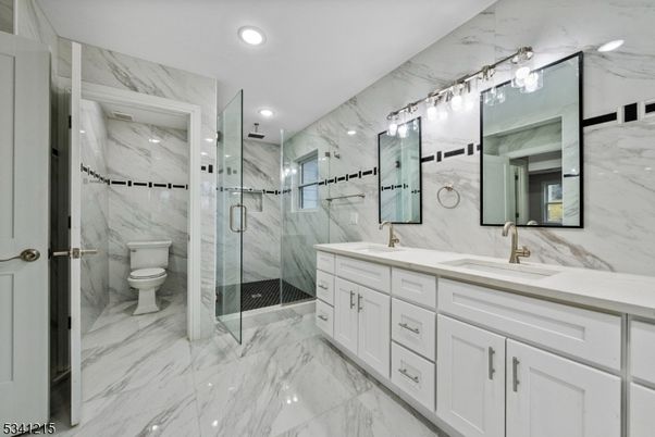 Bathroom, Dual Sink Vanities, Glass Shower, Interior, Marble, Marble Walls, Recessed Lighting