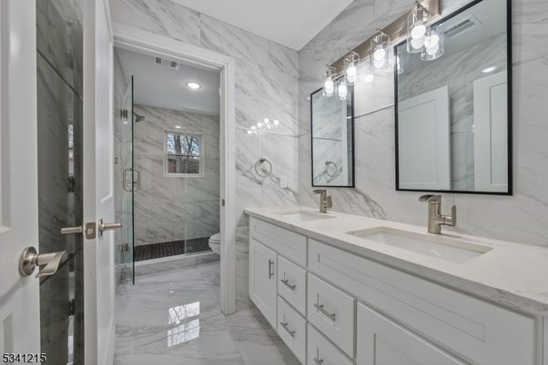 Bathroom, Dual Sink Vanities, Glass Shower, Interior, Marble, Marble Walls, Recessed Lighting